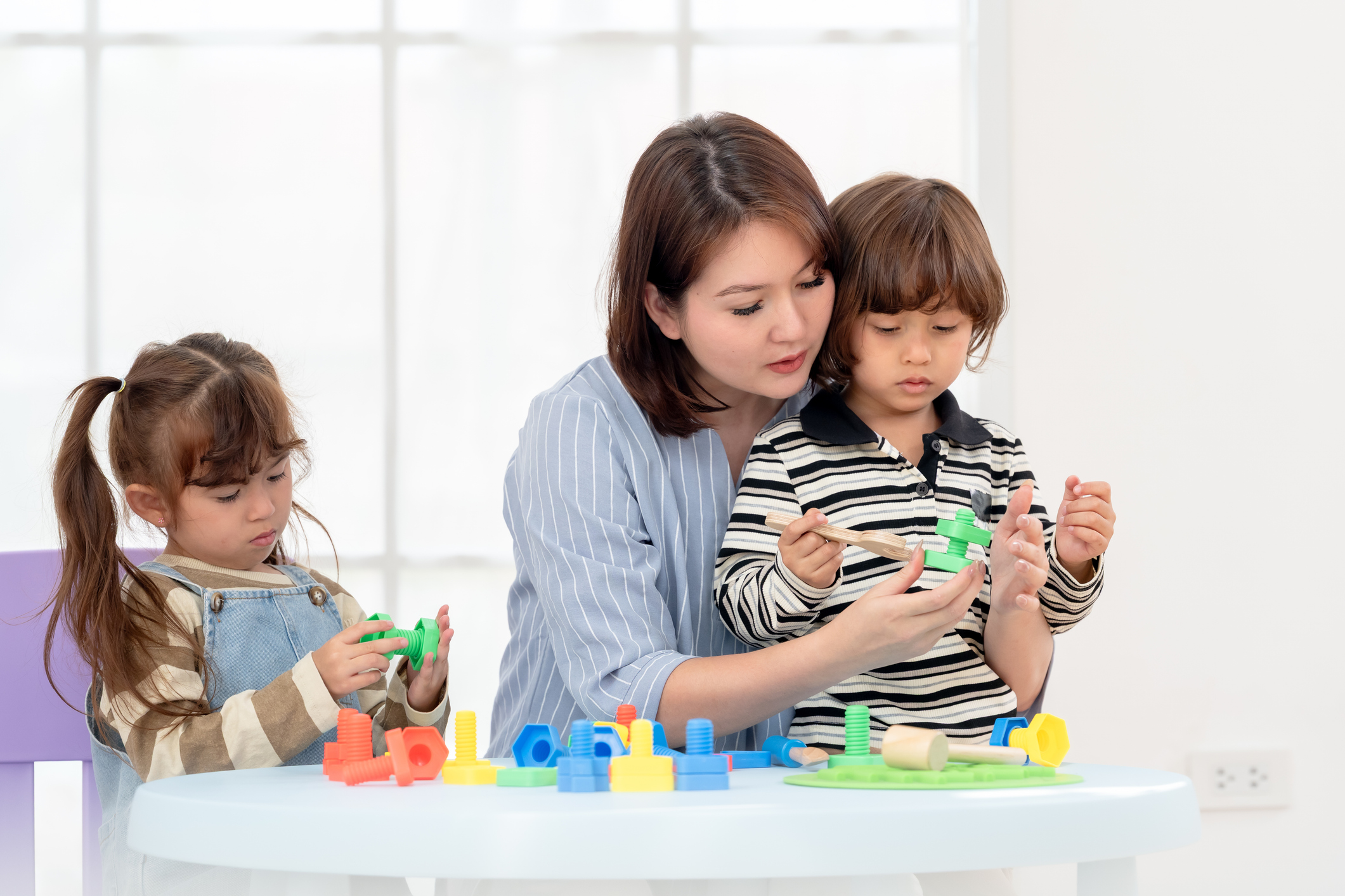 Preschool children practicing patience and taking turns during play
