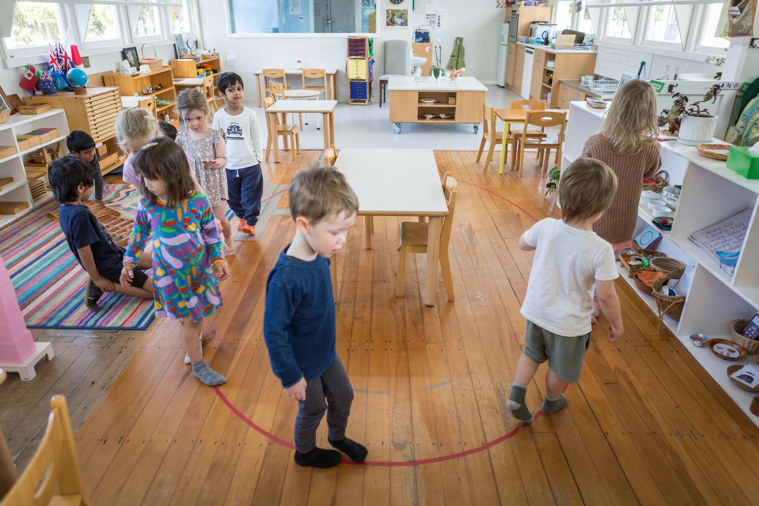 Preschool children practicing flexibility during a classroom routine