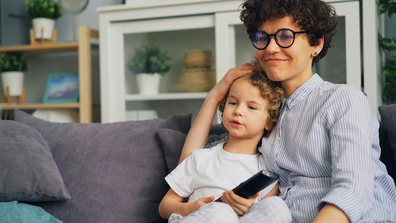 Parent and child watching TV together