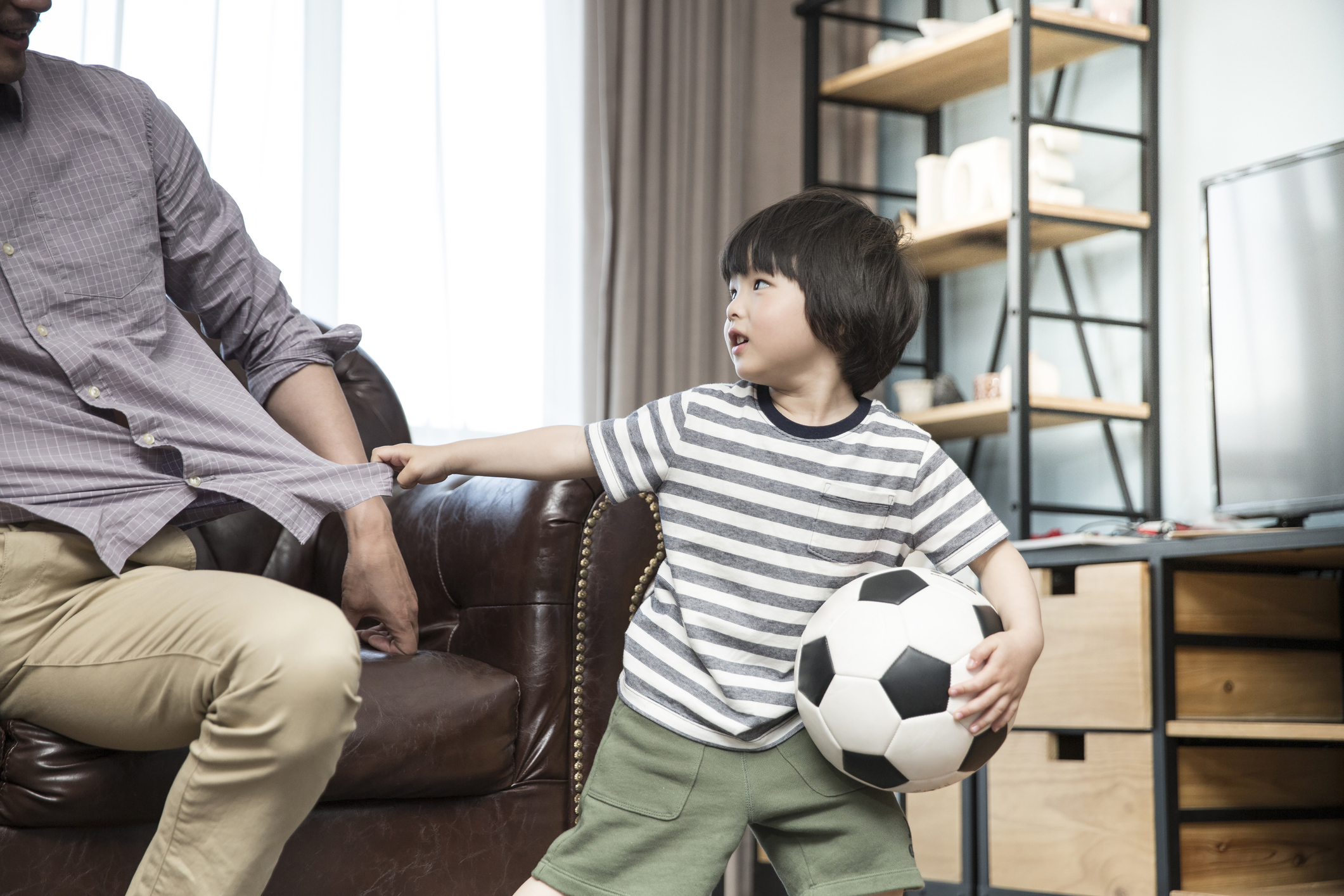 Caregiver acknowledging a child who is patiently waiting for attention