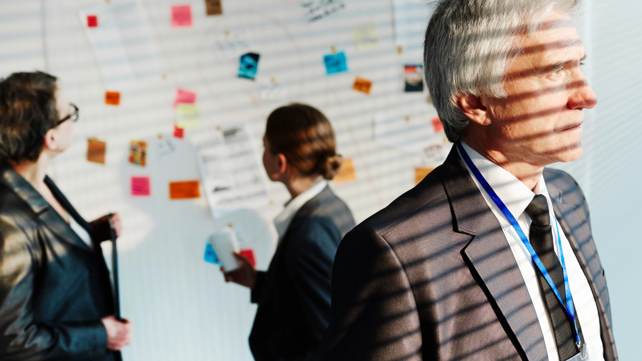 A reflective leader pausing to consider their response before taking action.