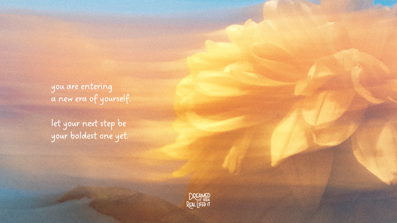 Dreamed It Then Real Lifed It podcast image of misty mountains in distance, big yellow flower on right side and the text "you are entering a new era of yourself, let your next step be the boldest yet"