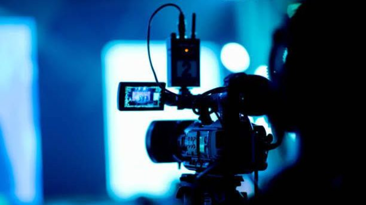 Church livestream setup with worship team, LED lyrics, and production crew during service