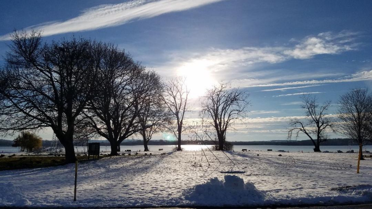 Sun shining over a snowy scene