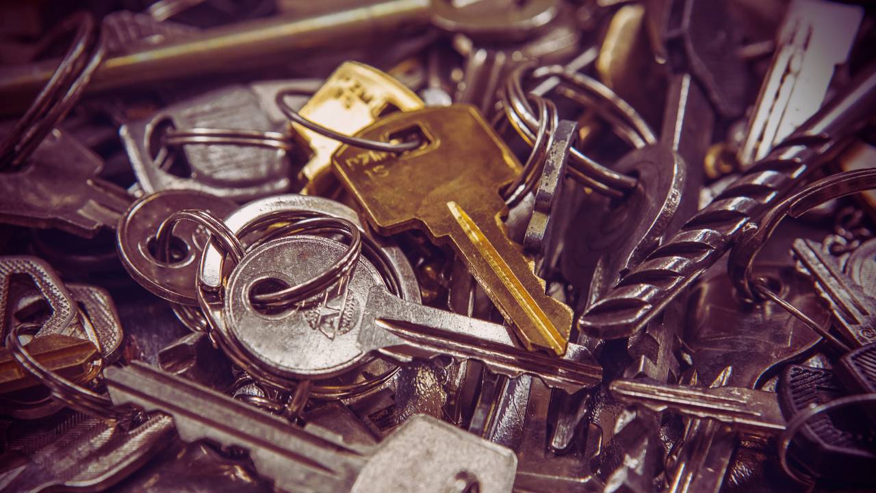 Burnout Recovery - The image shows a pile of assorted keys, including silver and gold-toned ones, creating a sense of clutter and mystery. Among the collection, a shiny golden key stands out prominently, drawing the eye amidst the otherwise duller keys. The close-up perspective and warm lighting give the photo a nostalgic and symbolic feel, suggesting themes of unlocking potential, exploring new opportunities, or leaving behind outdated approaches to embrace fresh paths.