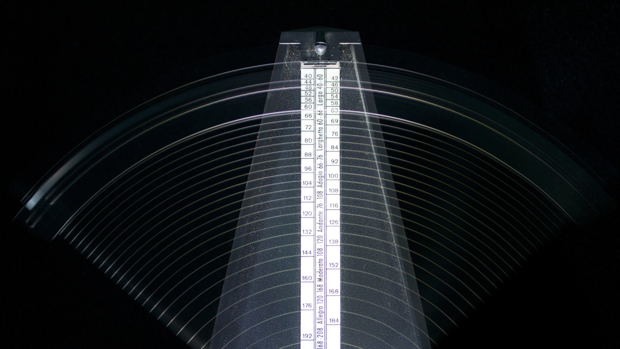 Metronome swinging in motion symbolizing leadership rhythm, influence, and authority in decision-making rooms.