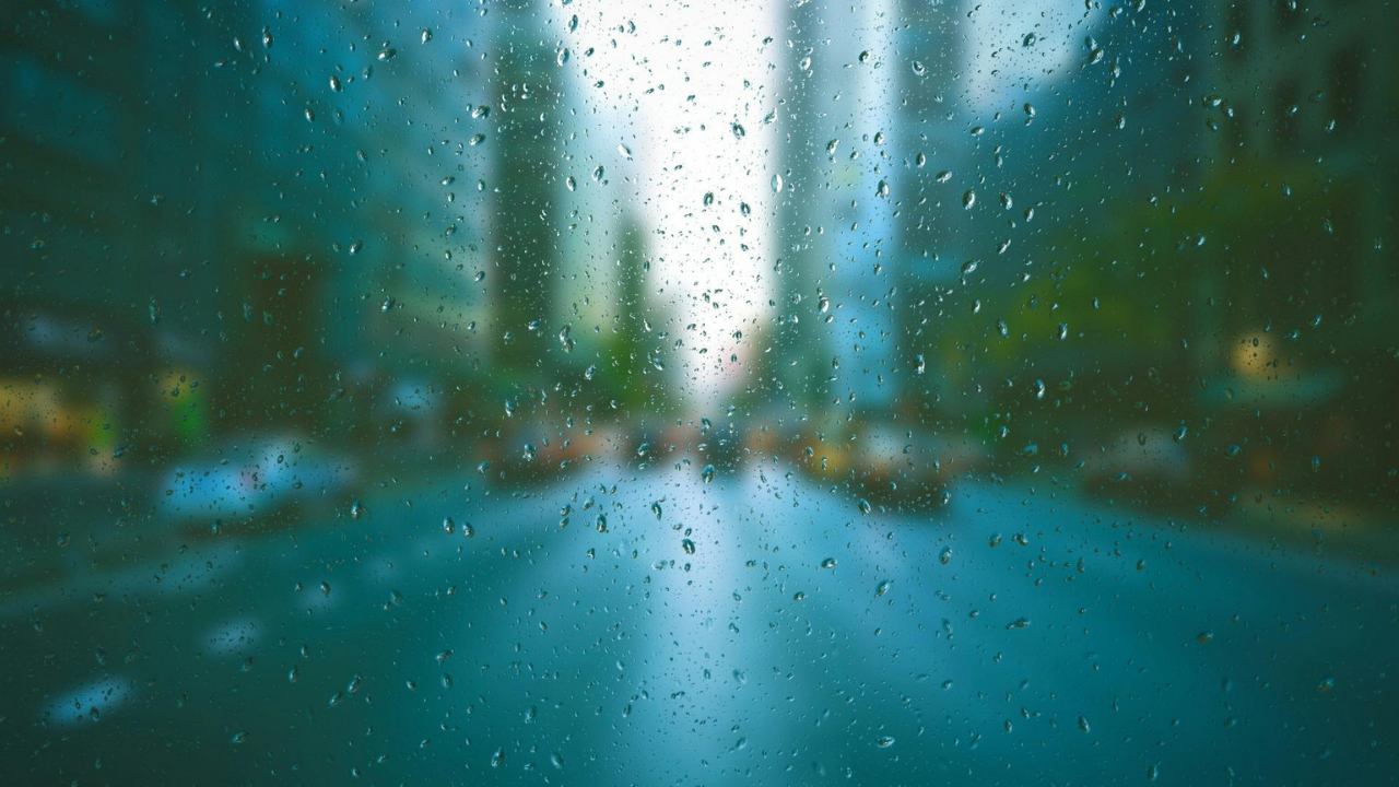 Blurred city street through rain representing the quiet erosion of judgment and leadership clarity. 