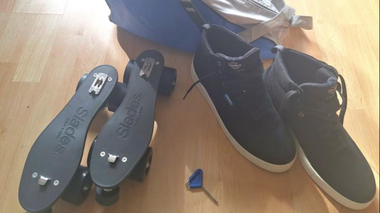 A pair of black Slades convertible roller skates (showing the boots dismounted from the roller skate plate)