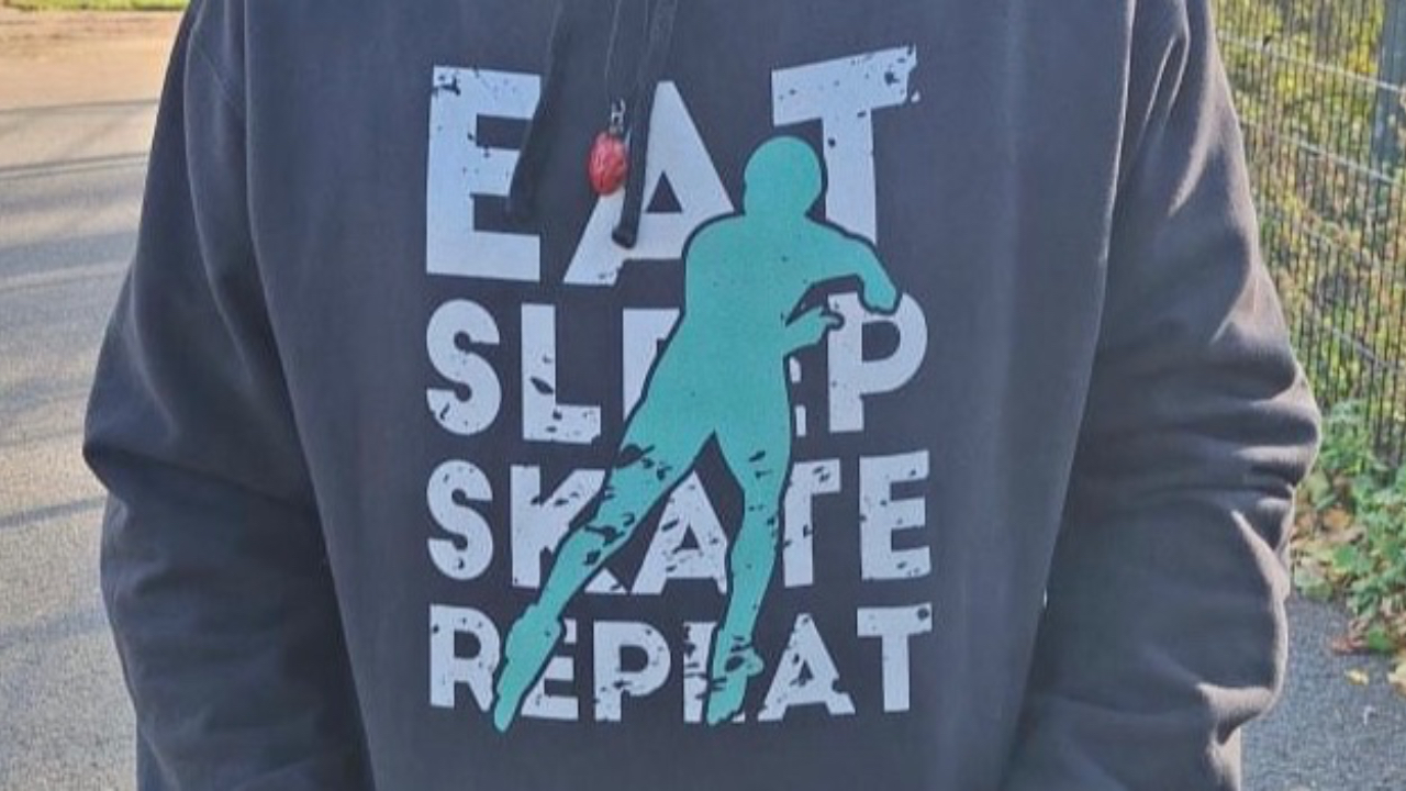 A black hoodie displaying the wirds, eat, skate, sleep, repeat