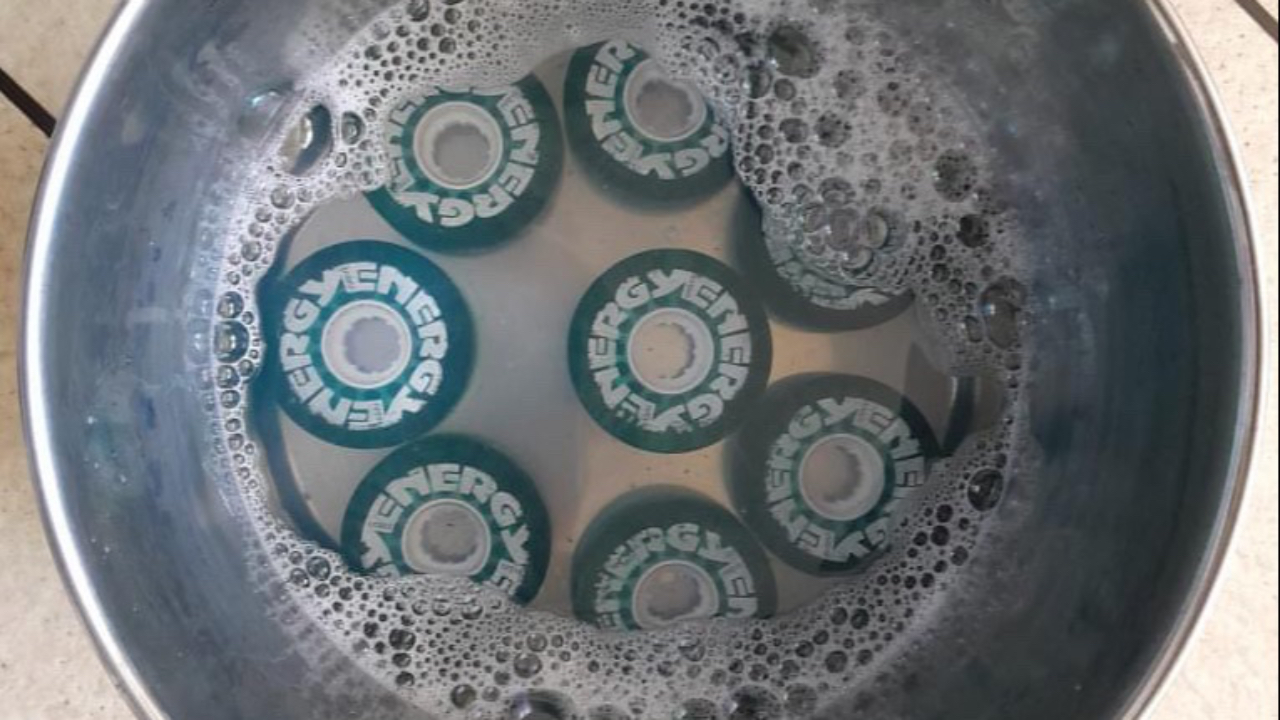 Image showing how to Dye your roller skate wheels in a large steel pot.