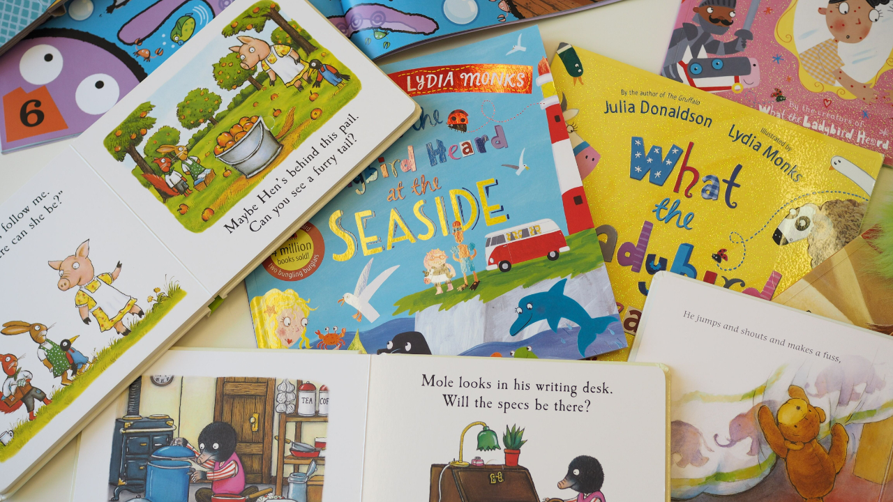 a pile of children's reading books being used as part of phonological activities at home