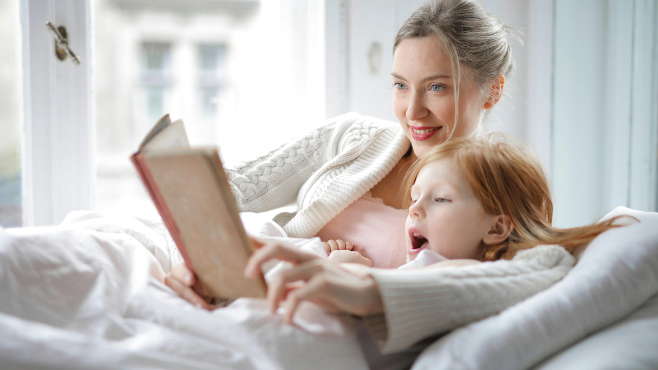 child and mother reading and working on language development milestones