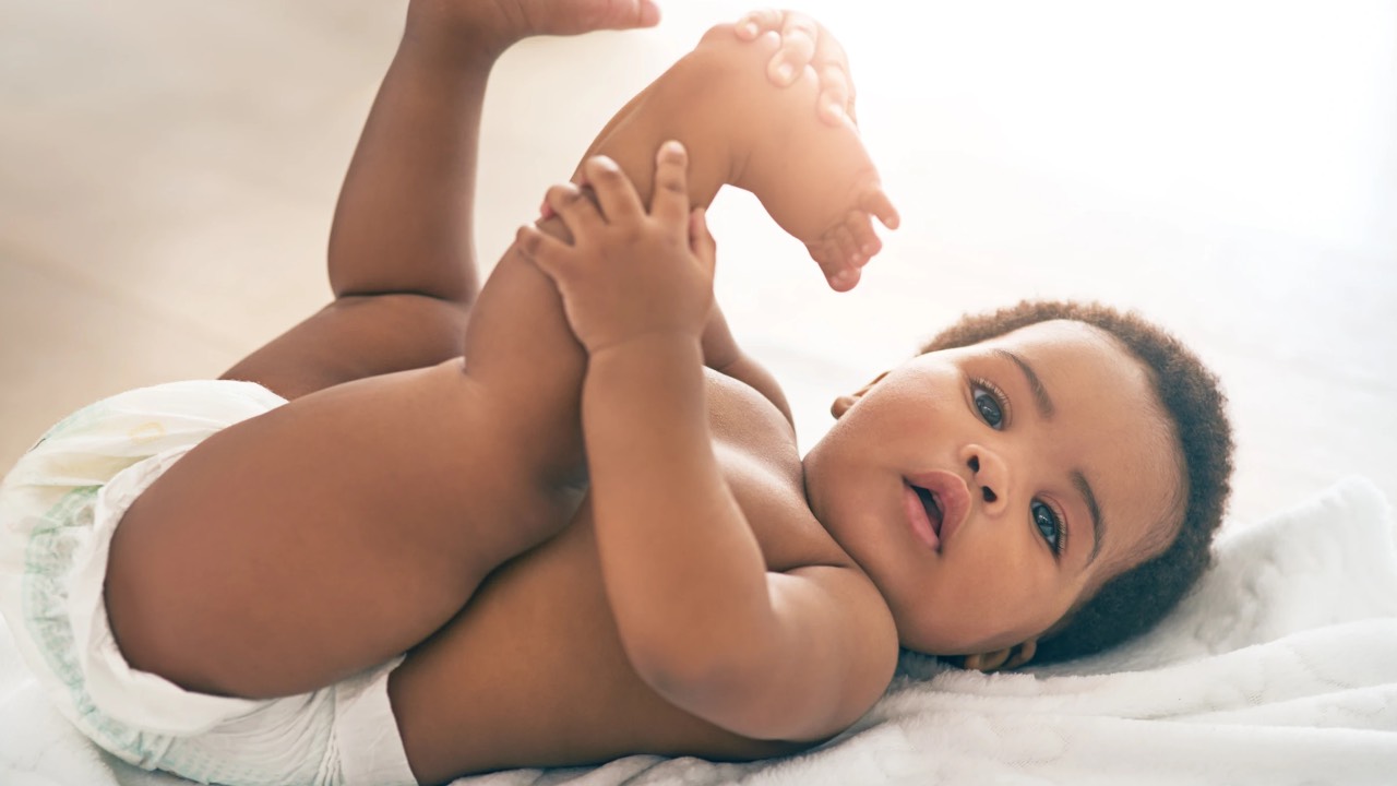 Baby holding his foot