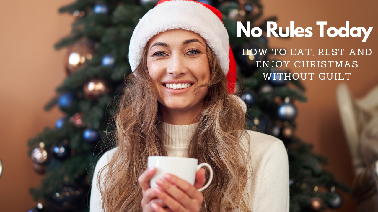 woman in front of xmas tree drinking a warm drink