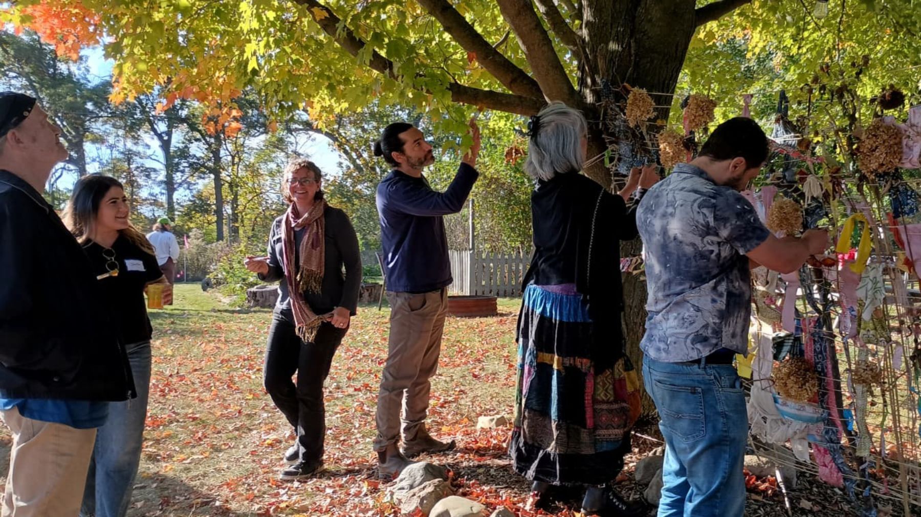 Participants at Garden Juju Collective and Gateway Farm events weave seasonal intentions into the Harvest Loom.