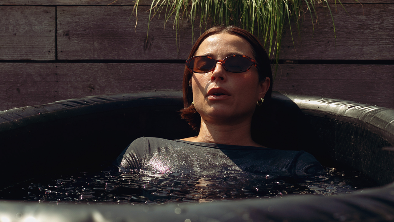 Cold plunge session at a wellness retreat showing contrast therapy practice for nervous system regulation