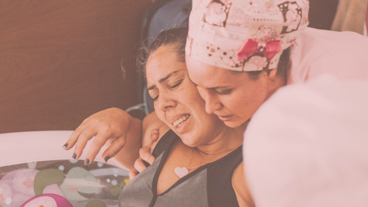 A doula supporting a woman giving birth