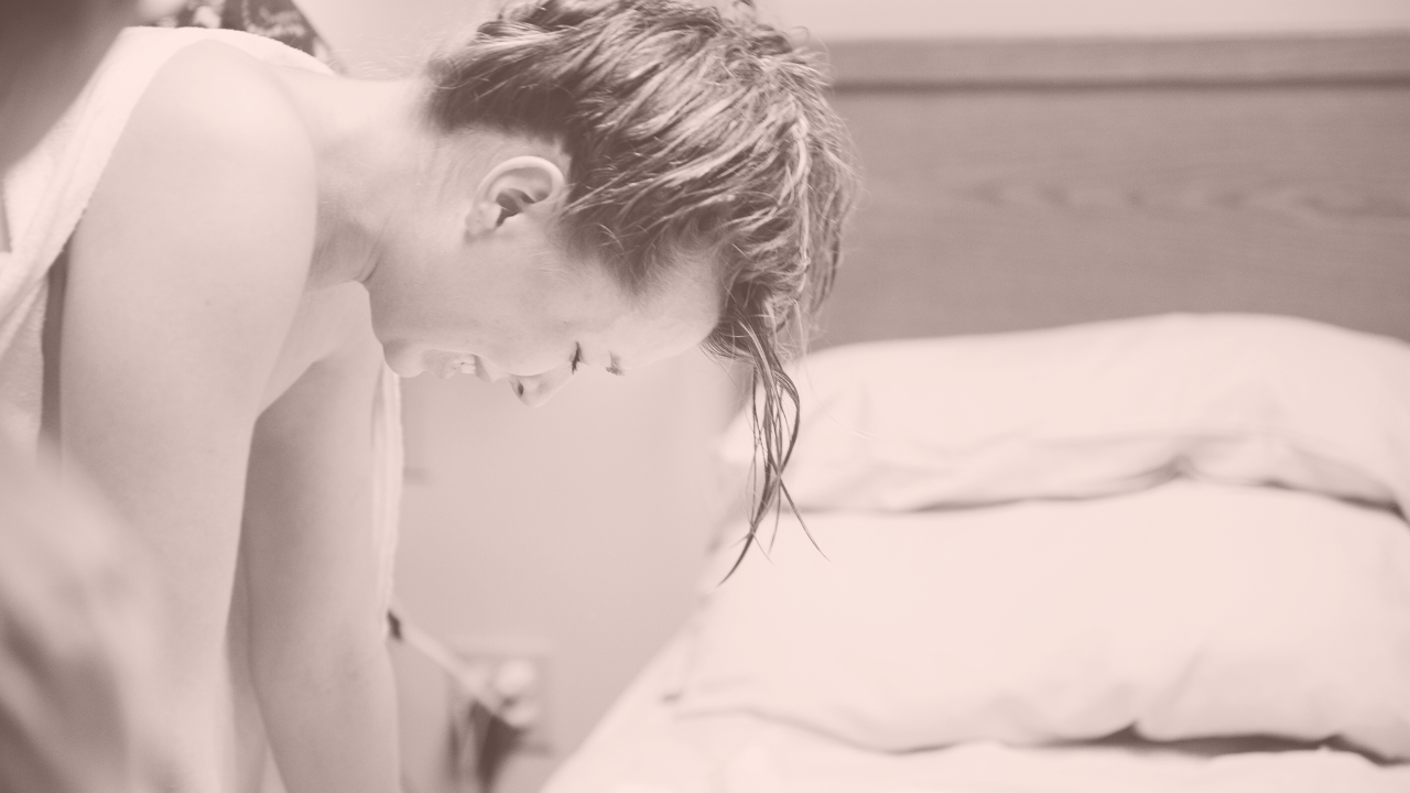 a pregnant woman bent over in pain