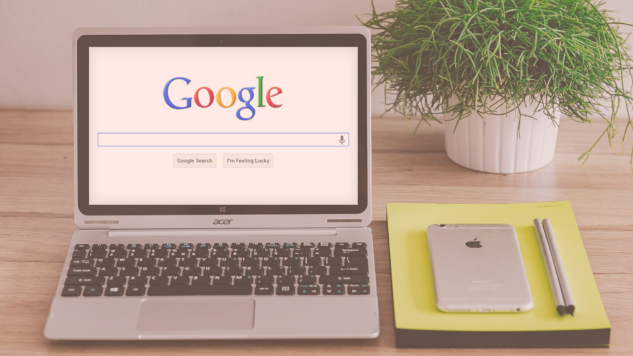 a desk set up with a google image on the laptop screen