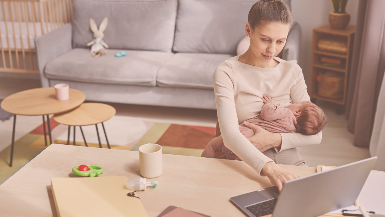 A mother breastfeeding in a working environment