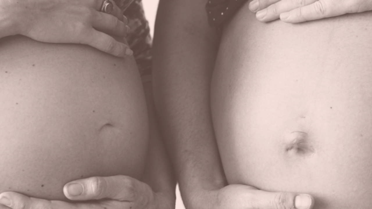 two pregnant women's bellies