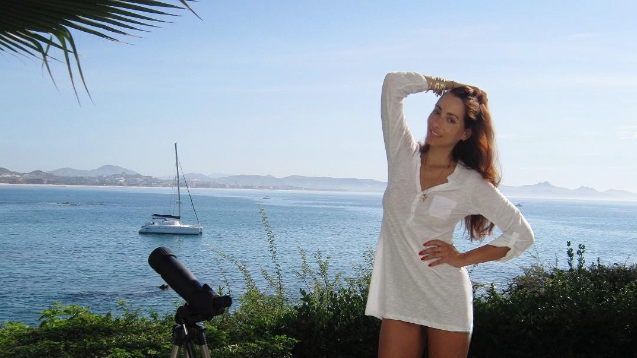 Sonia Doubell standing by the sea at sunrise, symbolizing new beginnings