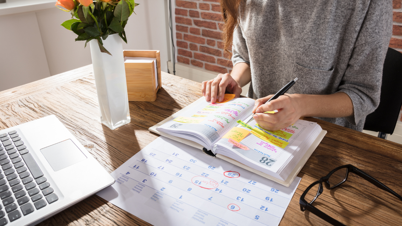 A woman working from home with a calendar or planner open