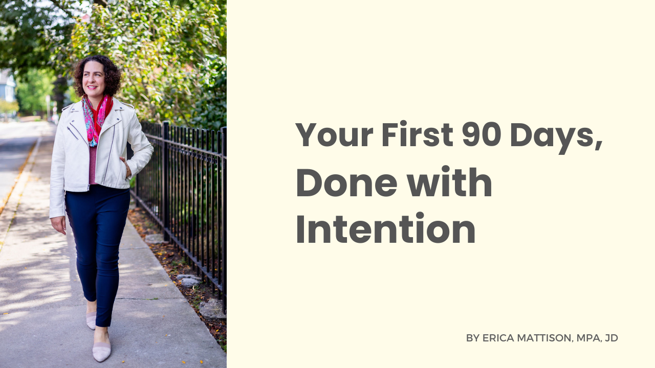 Erica Mattison walking confidently along a tree-lined sidewalk, smiling and wearing a light jacket and scarf, with text on the right that reads “Your First 90 Days, Done with Intention.”
