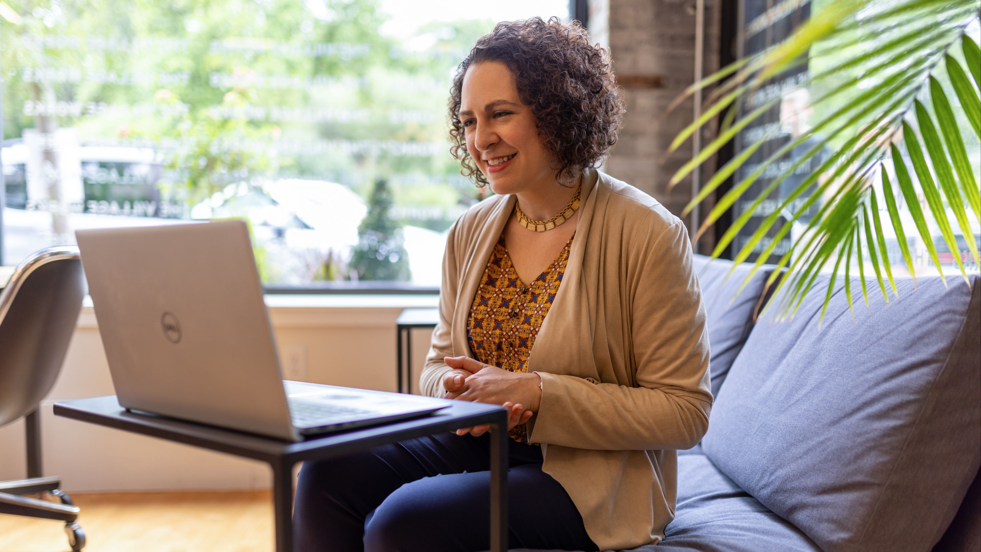 Erica Mattison seated at a computer during a video coaching consultation.