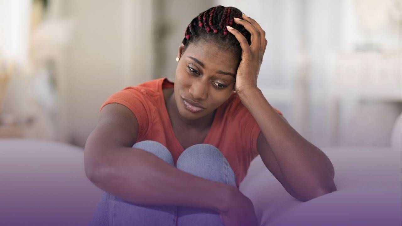woman on couch feeling sad