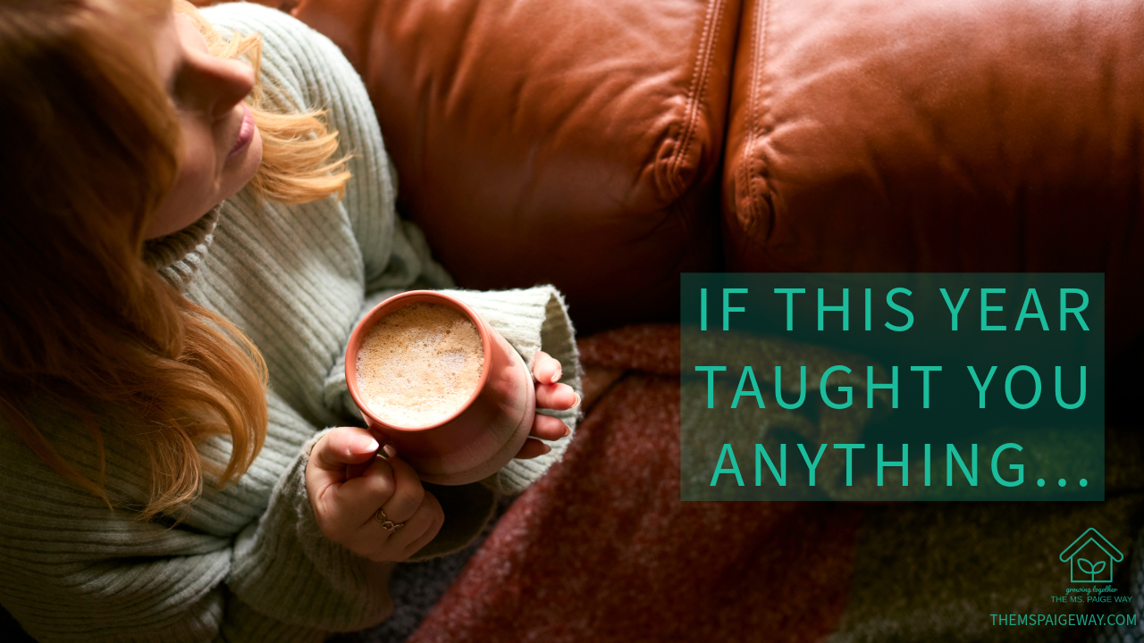 A person sitting on a couch holds a warm mug of coffee in both hands, wearing a cozy sweater in soft natural light. Overlaid text reads, “If this year taught you anything…” creating a calm, reflective mood.
