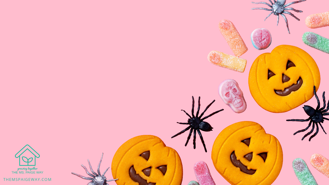 “Colorful Halloween candies and pumpkin cookies arranged with toy spiders on a soft pink background — playful flat lay for The Ms. Paige Way’s Halloween candy guide.”