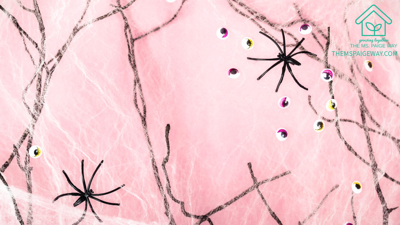 Soft pink background with delicate black spider webs and scattered googly eyes — a gentle Halloween design representing calm and connection from The Ms. Paige Way.