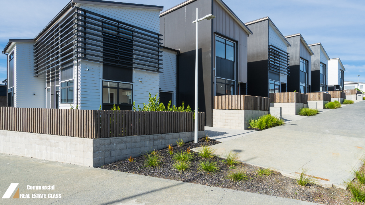 Modern row of multi-unit residential buildings representing the transition from residential to commercial real estate investing and multi-door opportunities