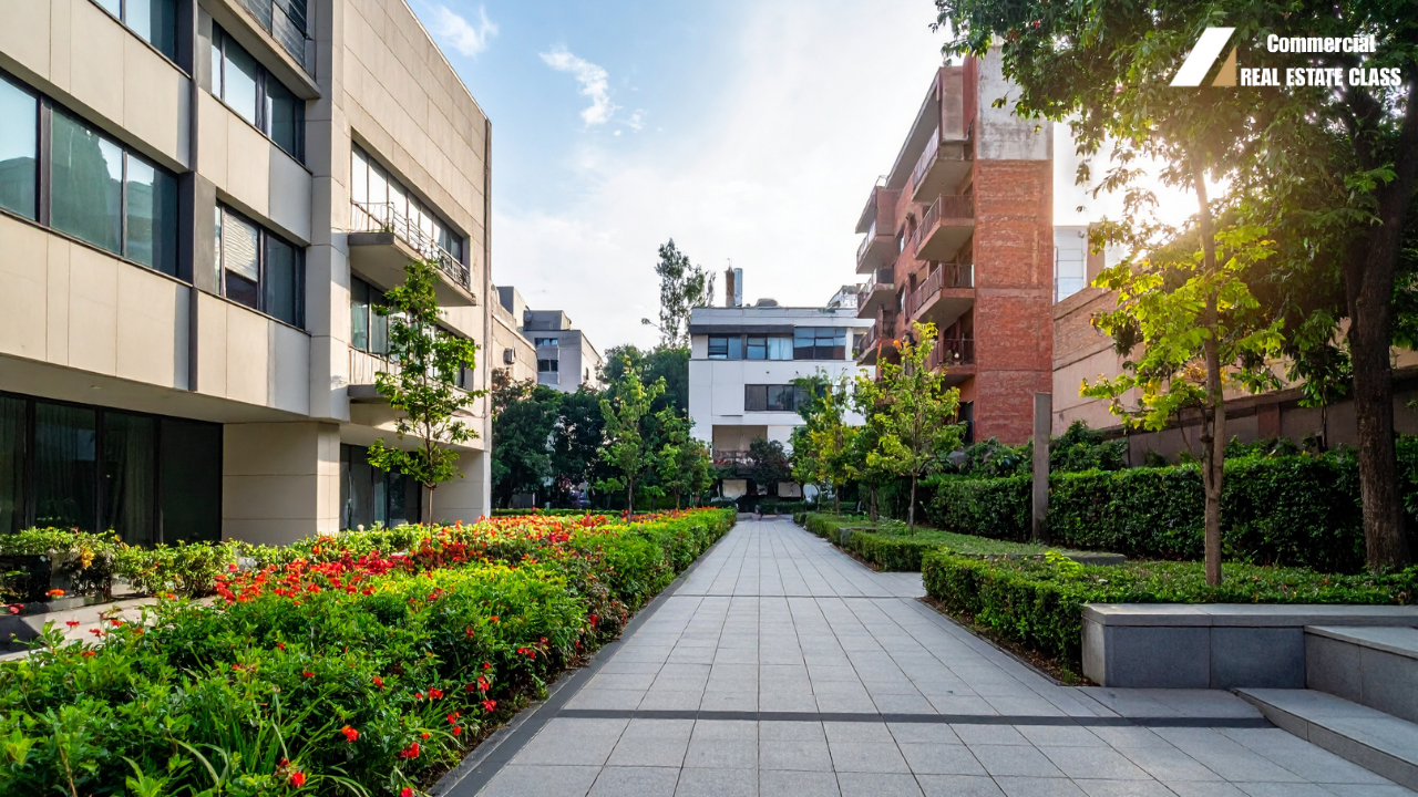 Large multifamily apartment building representing commercial real estate investing in income-producing rental housing properties.