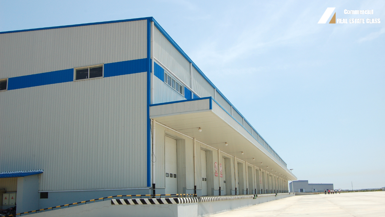 Large industrial warehouse and distribution center representing commercial real estate investments in logistics and e-commerce supply chain facilities.
