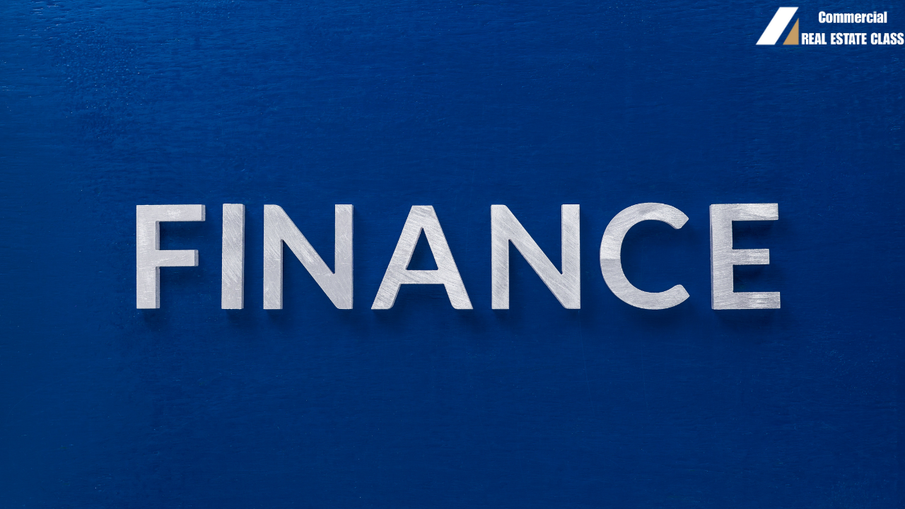 The word “FINANCE” displayed in bold letters on a blue background representing commercial real estate funding and loan concepts