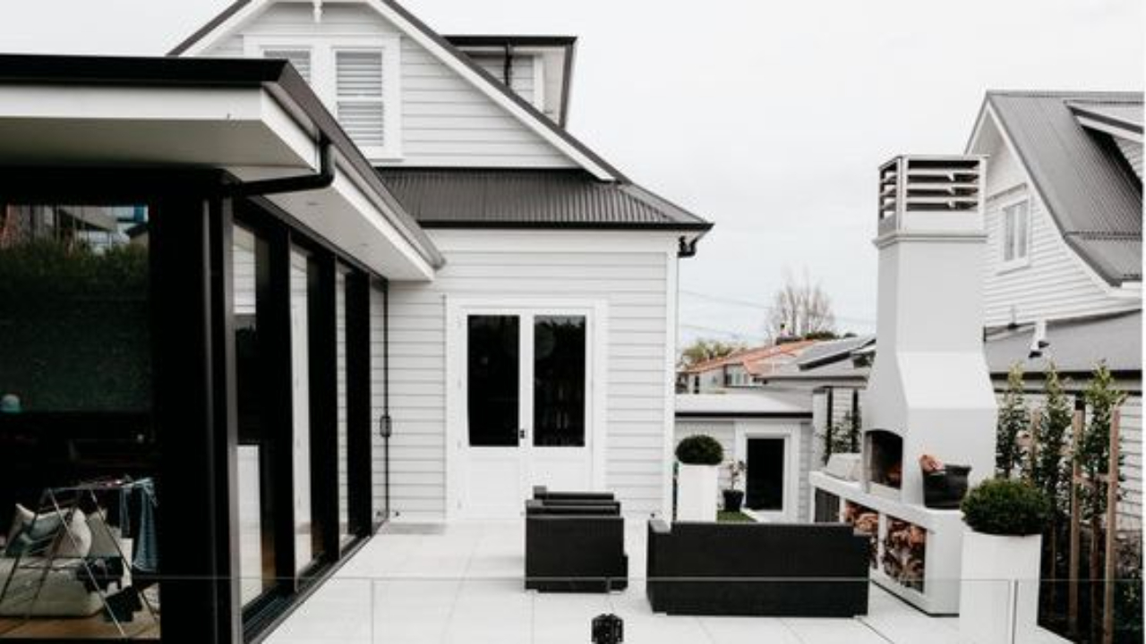 White weatherboard house with contemporary black section