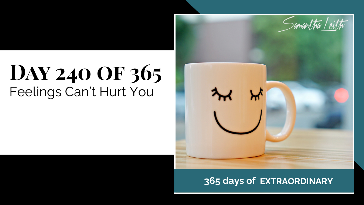 Motivational graphic by Samantha Leith. The text reads "DAY 240 OF 365 Feelings Can't Hurt You." The visual shows a white mug with a drawn face (closed eyes and a smile) sitting on a wooden table.