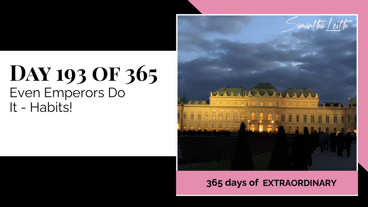 A photograph of the brightly lit, magnificent Schönbrunn Palace at dusk with people walking in the foreground, used to illustrate a blog post about building strong habits, historical routine, and the universal need for discipline, even for highly successful people.