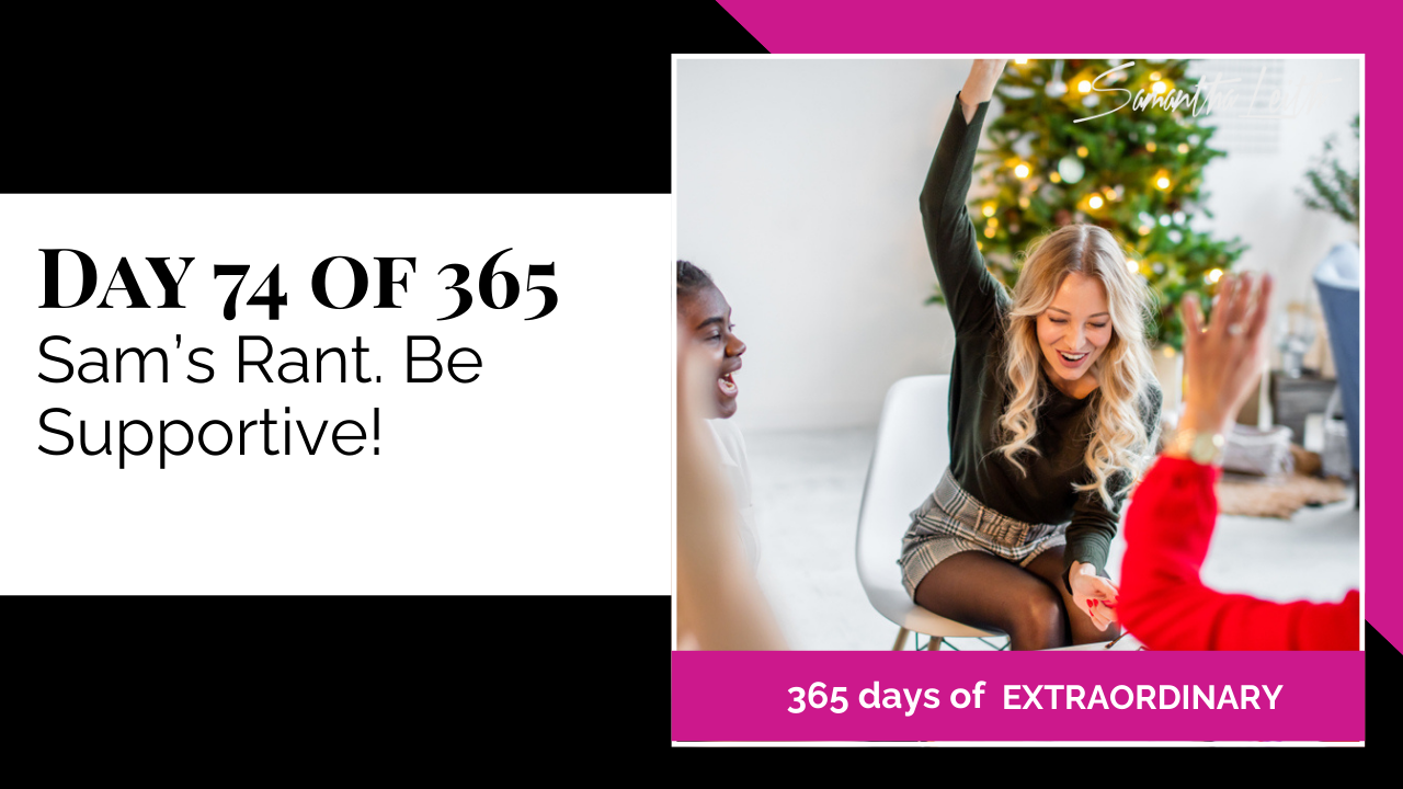 Blog thumbnail for 'Day 74 of 365: Sam's Rant. Be Supportive!' The visual shows a diverse group of people in an intimate setting, with one woman happily raising her hand while smiling, illustrating the importance of community, motivation, and being supportive of others' goals.