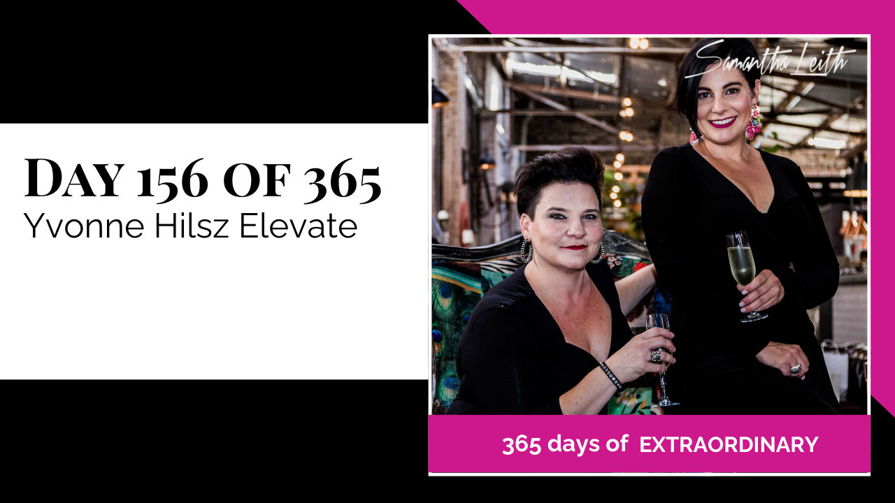Professional marketing image featuring two businesswomen—one sitting on a velvet chair and one standing—both wearing black and raising champagne glasses for a toast in an upscale venue, used to advertise the 'Yvonne Hilsz Elevate' program or interview.