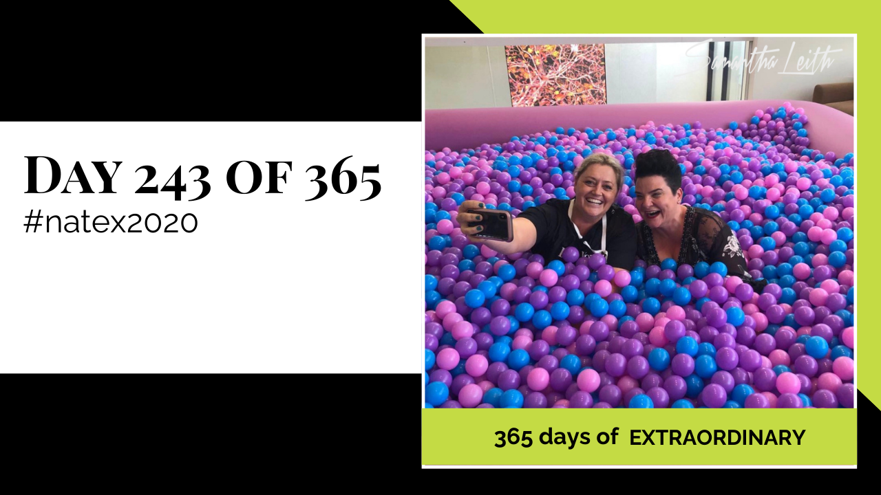 Promotional graphic from Samantha Leith's "365 days of extraordinary," Day 243: #natex2020. The image shows two women smiling and taking a selfie while submerged in a large ball pit filled with purple and blue plastic balls.