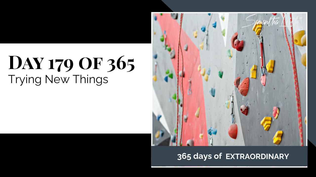 A perspective shot of an indoor rock climbing wall with safety gear attached, used as a powerful metaphor for embracing new experiences, taking calculated risks, and venturing out of one's comfort zone for personal growth.