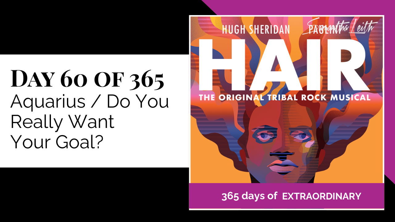 Thumbnail graphic for the topic, 'Aquarius / Do You Really Want Your Goal?' The image is a purple and orange poster design for the musical 'Hair: The Original Tribal Rock Musical,' featuring large text and an abstract illustration of a person with flowing, colorful hair. The visual reference to 'Hair' suggests themes of freedom, authenticity, or ambition.