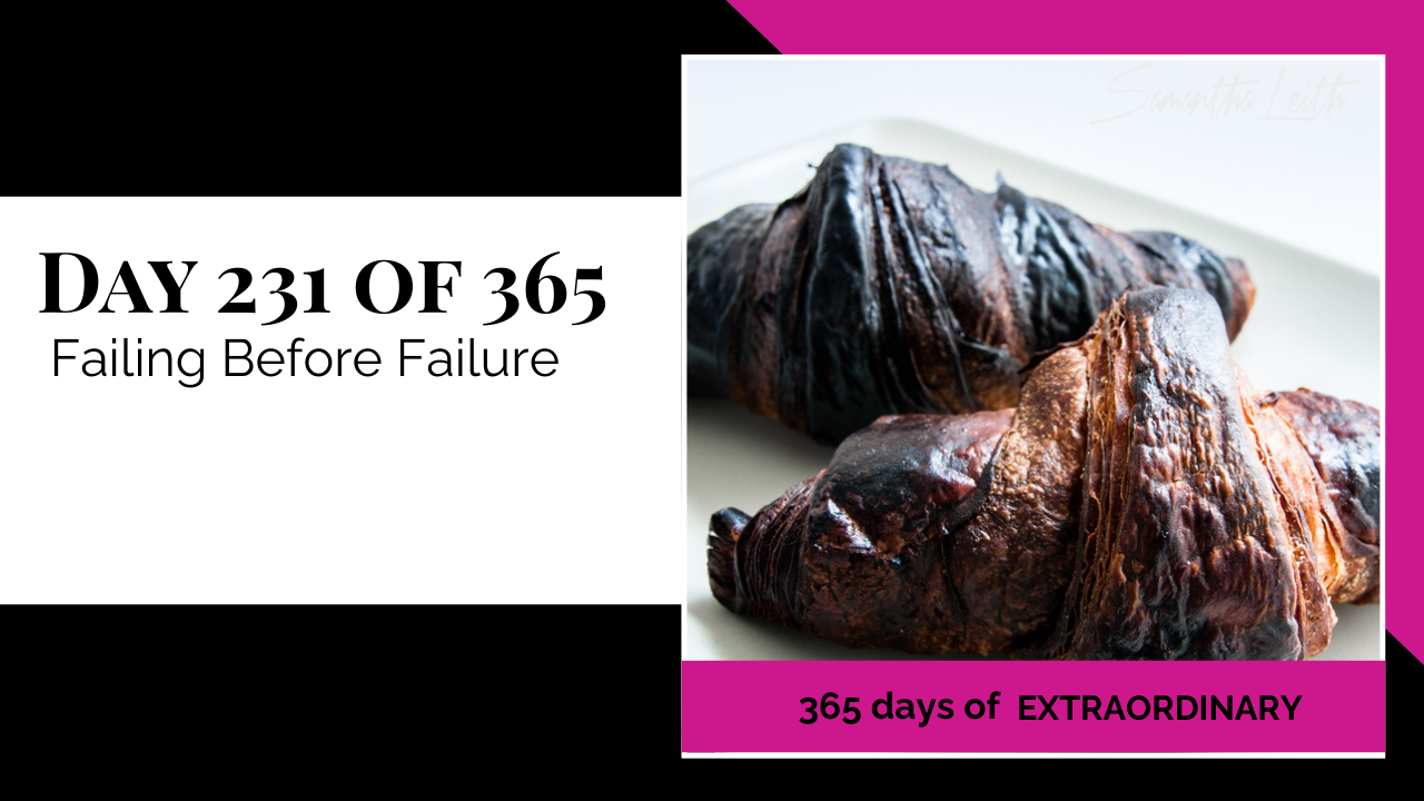 A photographic post featuring a close-up image of two dark, heavily browned, or burnt croissants resting on a white plate. The croissants appear overcooked, with very dark, almost black surfaces. The image is split with a title card on the left side that reads: "DAY 231 OF 365 Failing Before Failure". Below the photo, a bright pink banner reads: "365 DAYS OF EXTRAORDINARY". A stylized signature in the top right corner says "Samantha Leith."