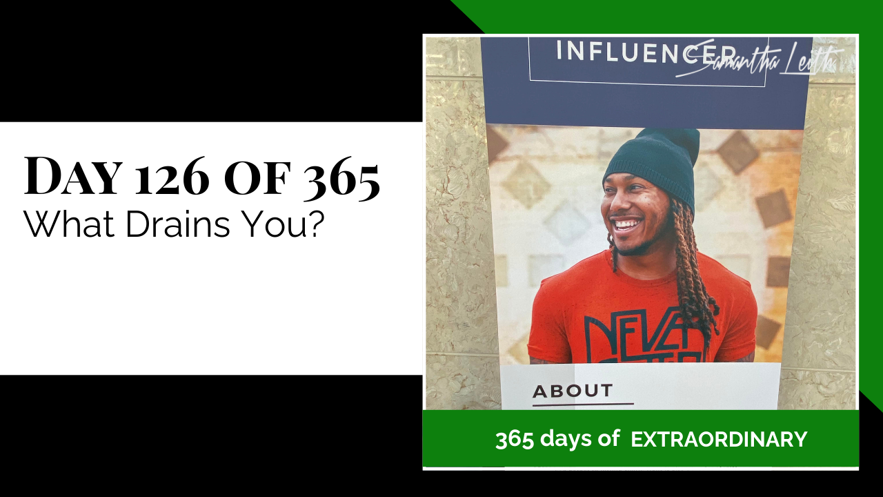 Blog image for Day 126 of Sam Leith's '365 Days of Extraordinary' series, featuring a close-up image of a man with long dreadlocks and a beanie wearing an orange t-shirt, smiling broadly, prominently displayed on a large event poster labeled 'INFLUENCER' and 'ABOUT', related to energy, focus, and overcoming draining influences.