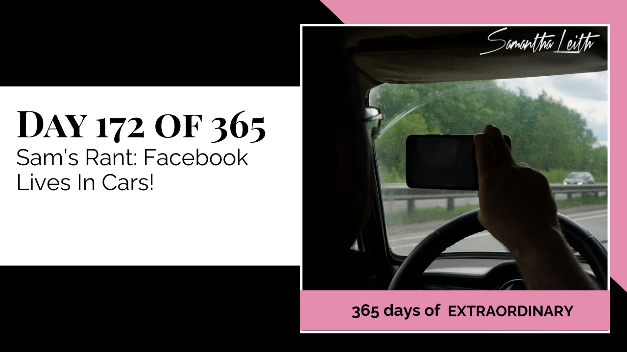 POV image from the driver's seat showing a person holding a phone for recording or live streaming with their right hand while gripping the steering wheel, used to illustrate a discussion about the danger of distracted driving, smartphone use in cars, and social media live videos.