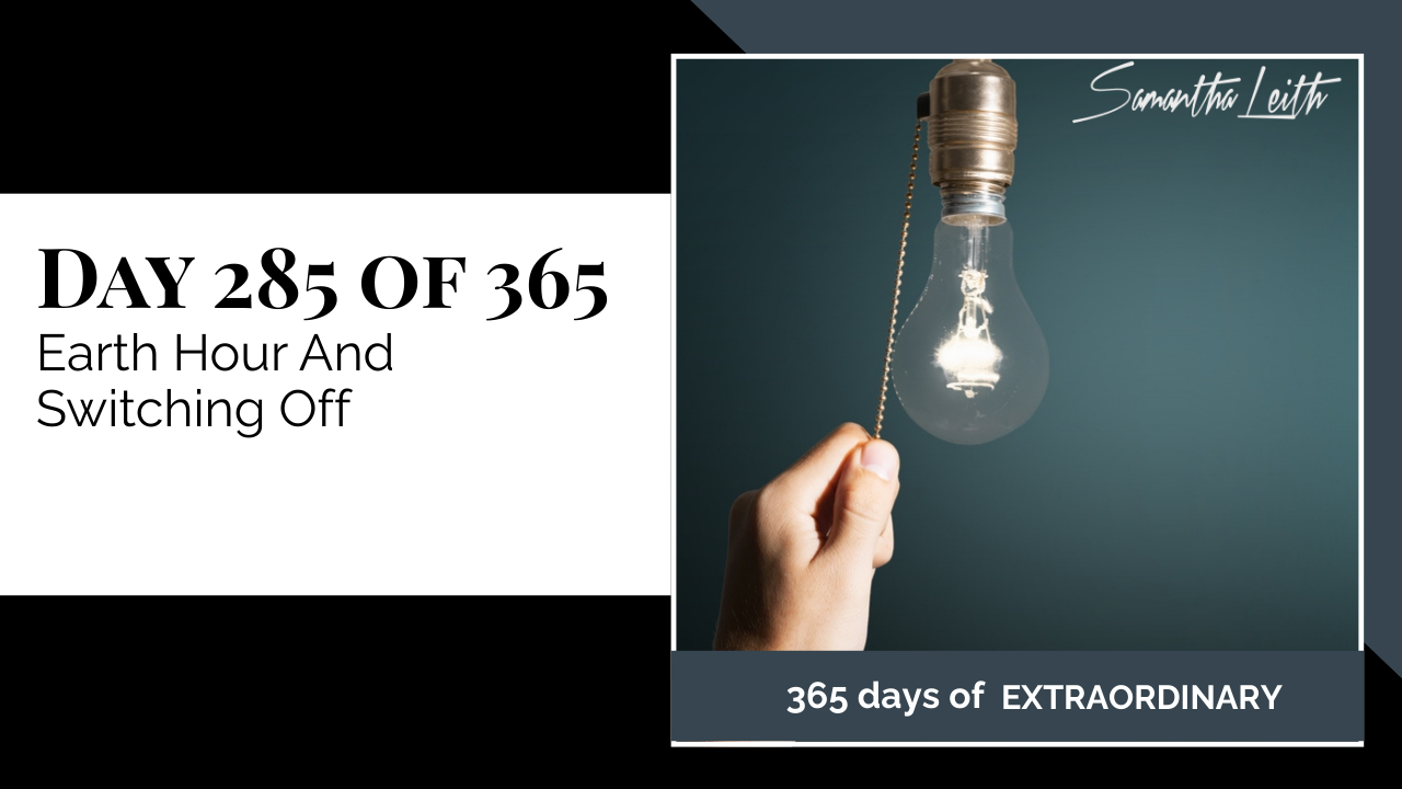 Graphic for Samantha Leith's "365 Days of Extraordinary" series. Text on the left reads "Day 285 of 365: Earth Hour And Switching Off." The right side shows a hand reaching up to pull the chain of a lit vintage light bulb against a dark teal background.