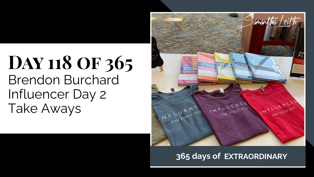 Blog image for Day 118 of Sam Leith's '365 Days of Extraordinary' series, showing a table display with various colored high-performance planners and 'INFLUENCER' t-shirts from the San Diego 2019 event.